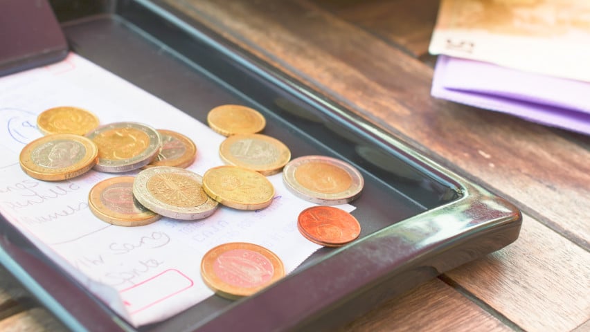 Euro coins and a check