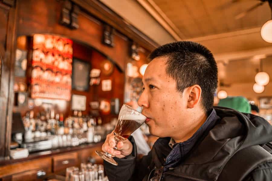 A man drinking an Irish coffee
