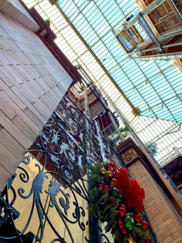 Bradbury Building displaying ironwork, skylight, and festive wreath