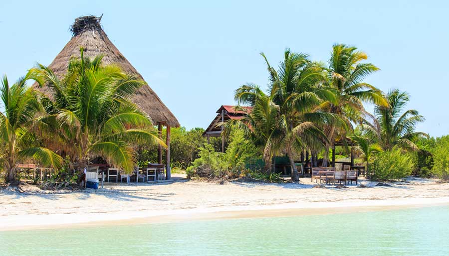 View nipa hut on the Isla Contoy under the clear blue sky