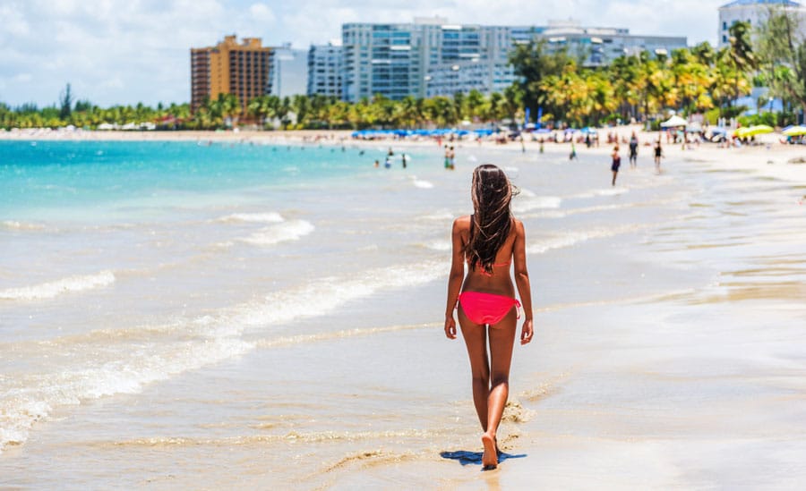 View of a woman walking by the beach in Isla Verde