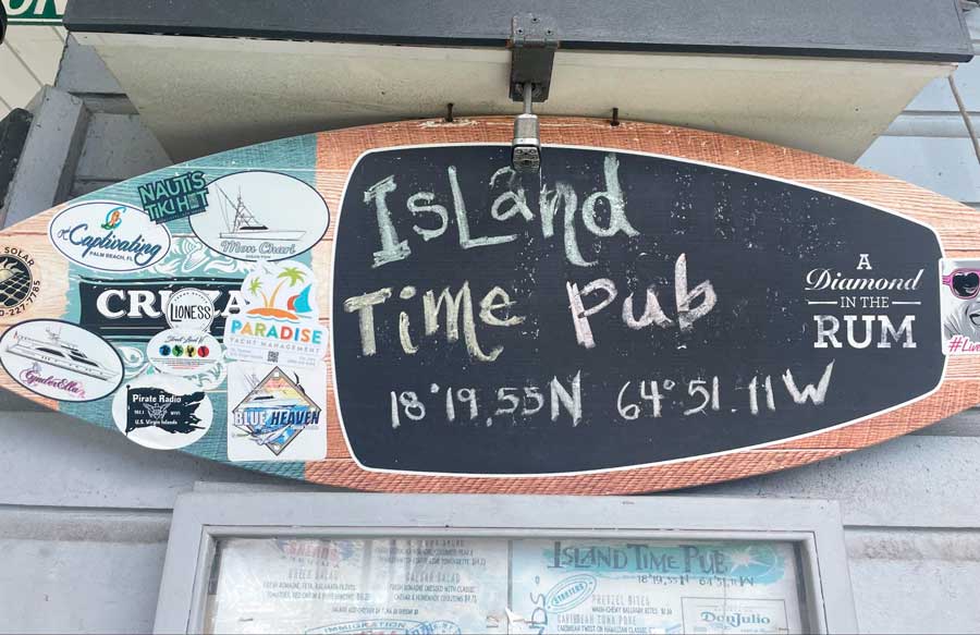 The Island Time Pub name on a surfboard displayed on the store