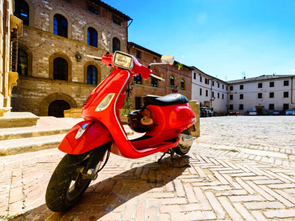 A red Italian Piaggio Vespa scooter in Tuscany, Italy