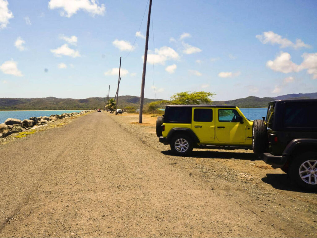 Two rented jeeps parked at the side of the road