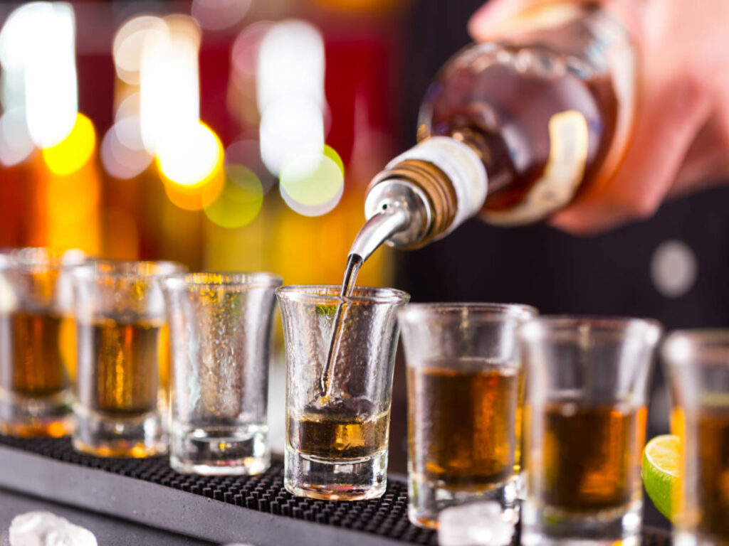 A bartender pouring Jeppson's Malört on a glass