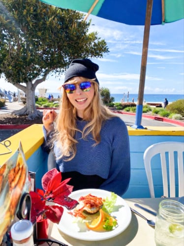 The author Jericha Griffin with her breakfast at a café next to Main Beach Park