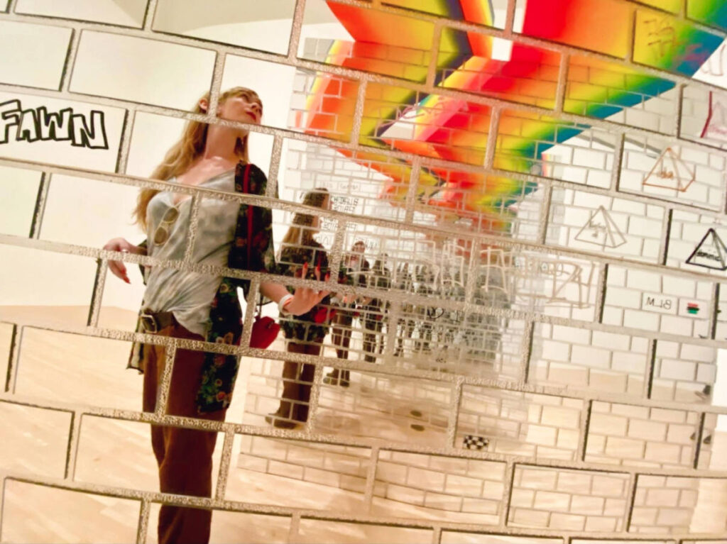The author Jericha Griffin, taking a photo with her reflection at Museum of Contemporary Art