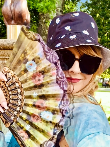 The author Jericha Griffin, posing with the fan merchandise from The Hand Fan Museum