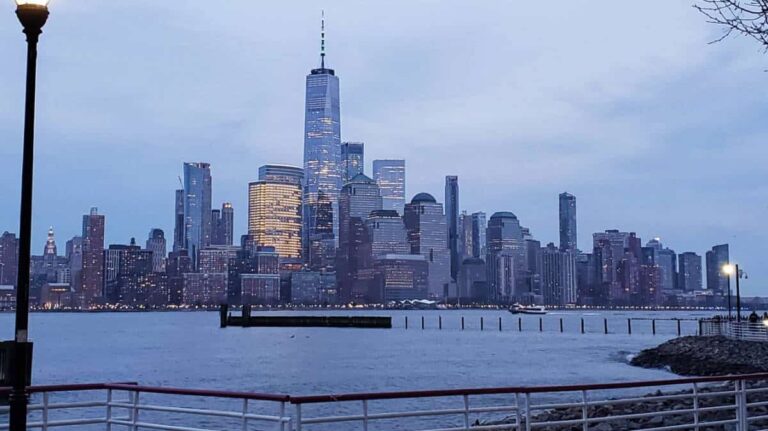 View of city skyline from the Newport Waterfront at dusk
