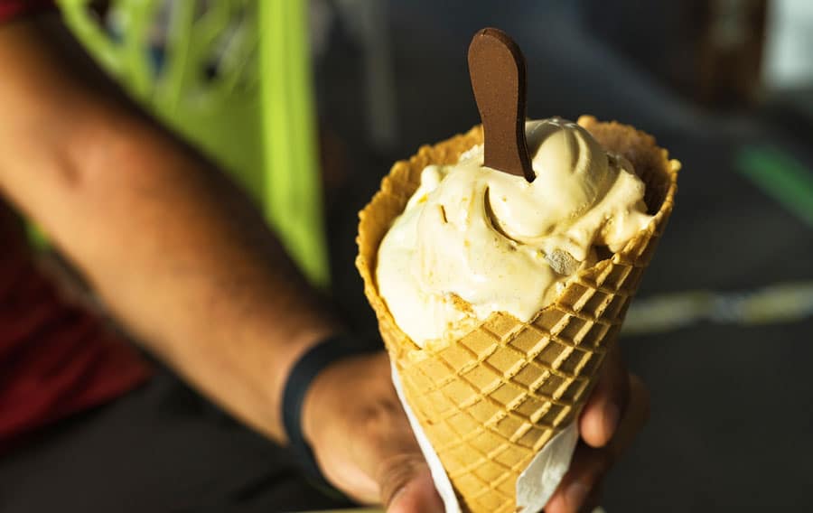 A man holding a cone of ice cream