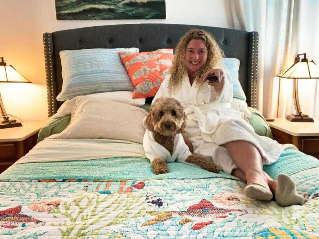 The author Jess Levy with her dog chilling on the hotel bed