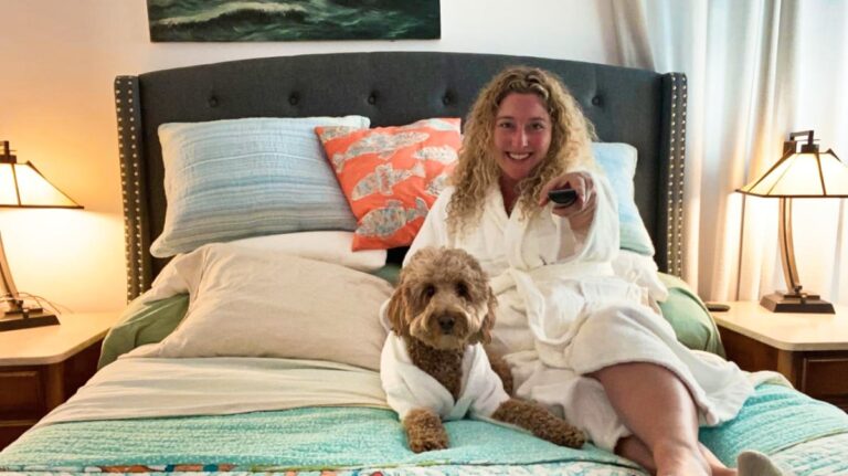 The author Jess Levy with her dog chilling on the hotel bed