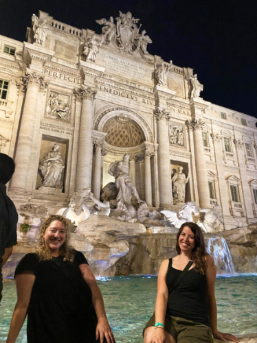 The author Jess and her friend posing for a photo at the Trevi Fountain