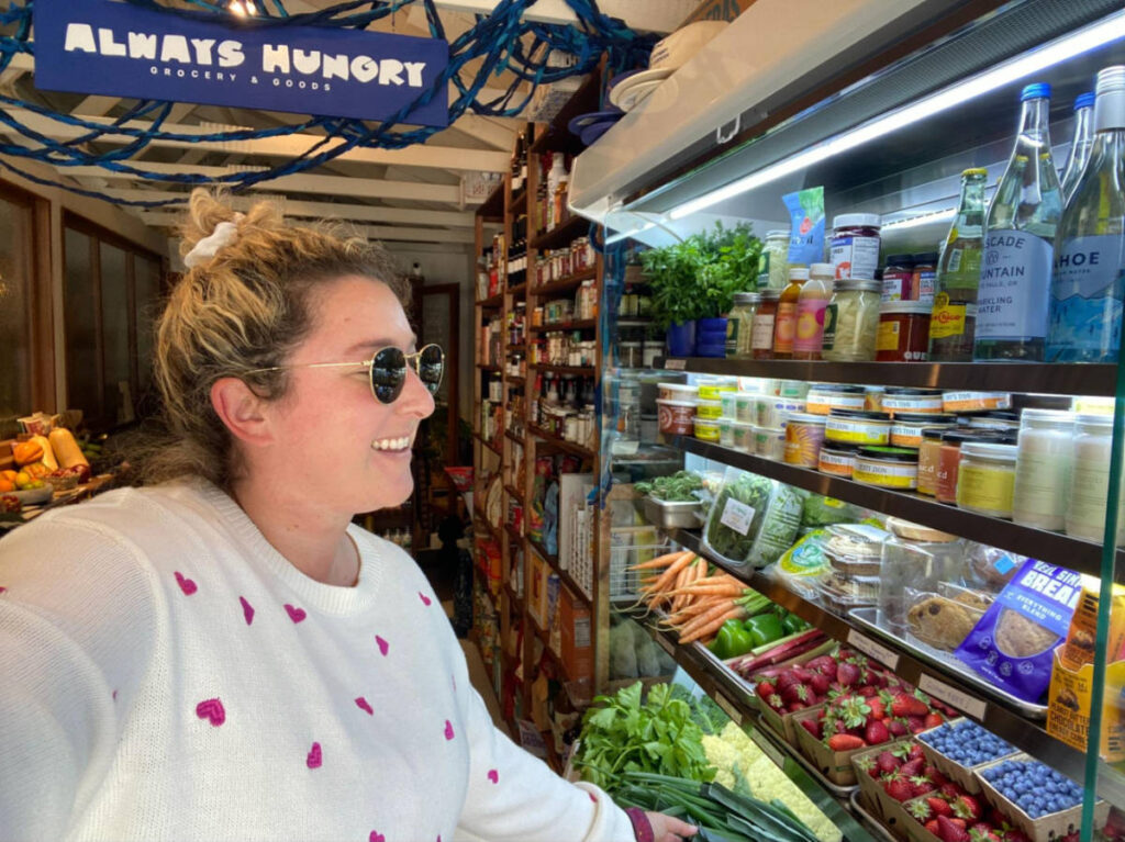The author Jess Levy looking at the displays in  Always Hungry Grocery & Goods