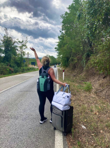 The author Jess posing for a photo with her baggage