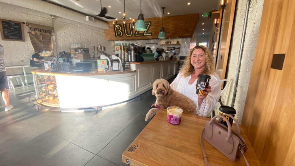 The author Jess Levy and her dog with their food and drinks from Better Buzz