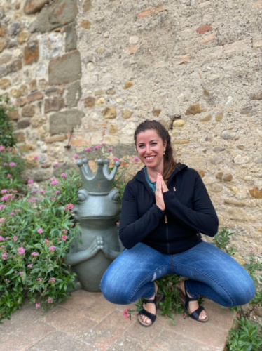 The author's friend posing for a photo while squatting
