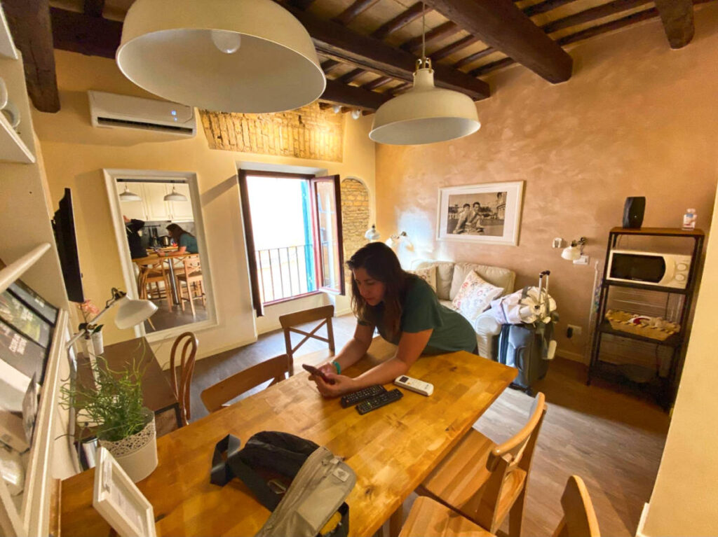 The author's friend leaning on the table inside their accommodation