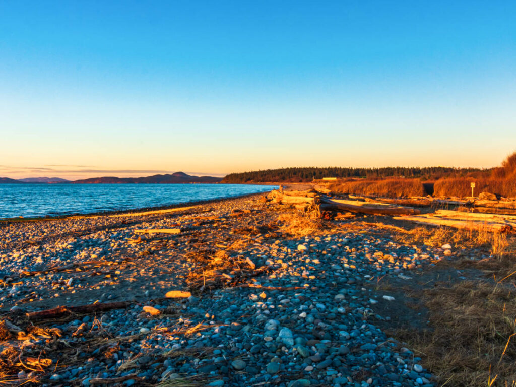 Scenic view of the sunset reflecting on the beach at Joseph Whidbey State Park