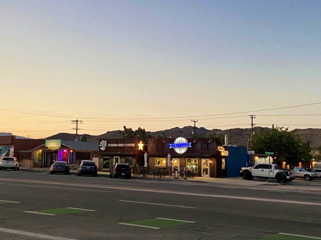 View of the Joshua Tree Coffee Co. from across the street at dusk