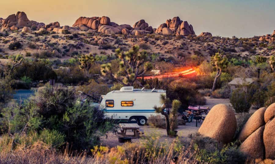 Landscape view of Joshua Tree National Park with a camper van in the campground