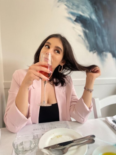 The author, Claudicet Pena enjoying her wine at KAVA Neo-Taverna in Boston