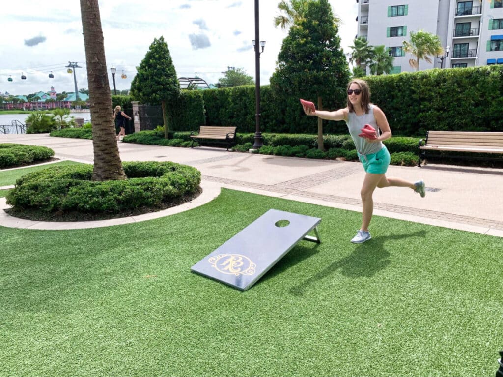 The author Katie Neufeld playing the cornhole at Disney’s Riviera Resort