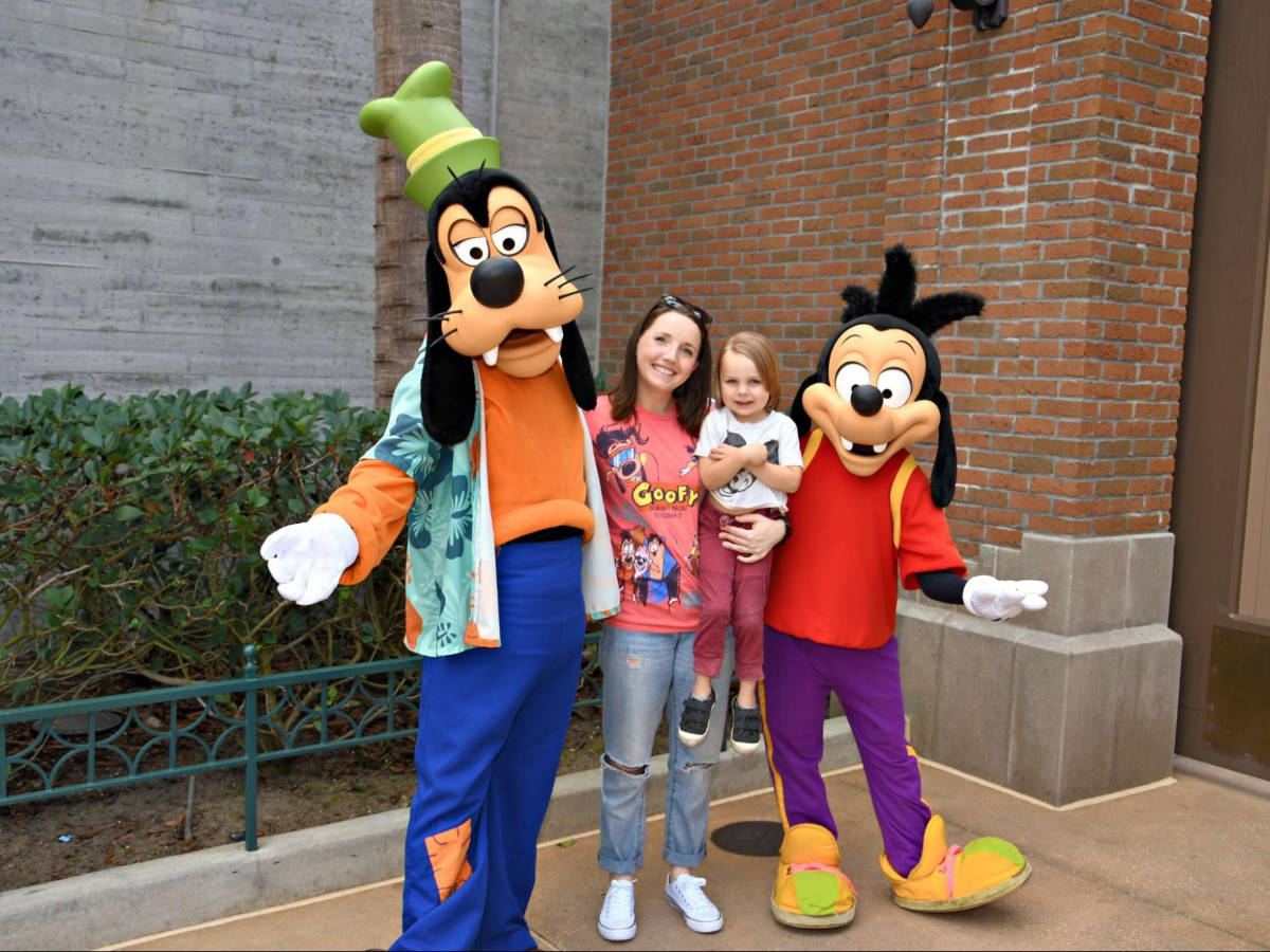 The author Katie and her son posing for a photo with Max and Goofy at Disney’s Hollywood Studios