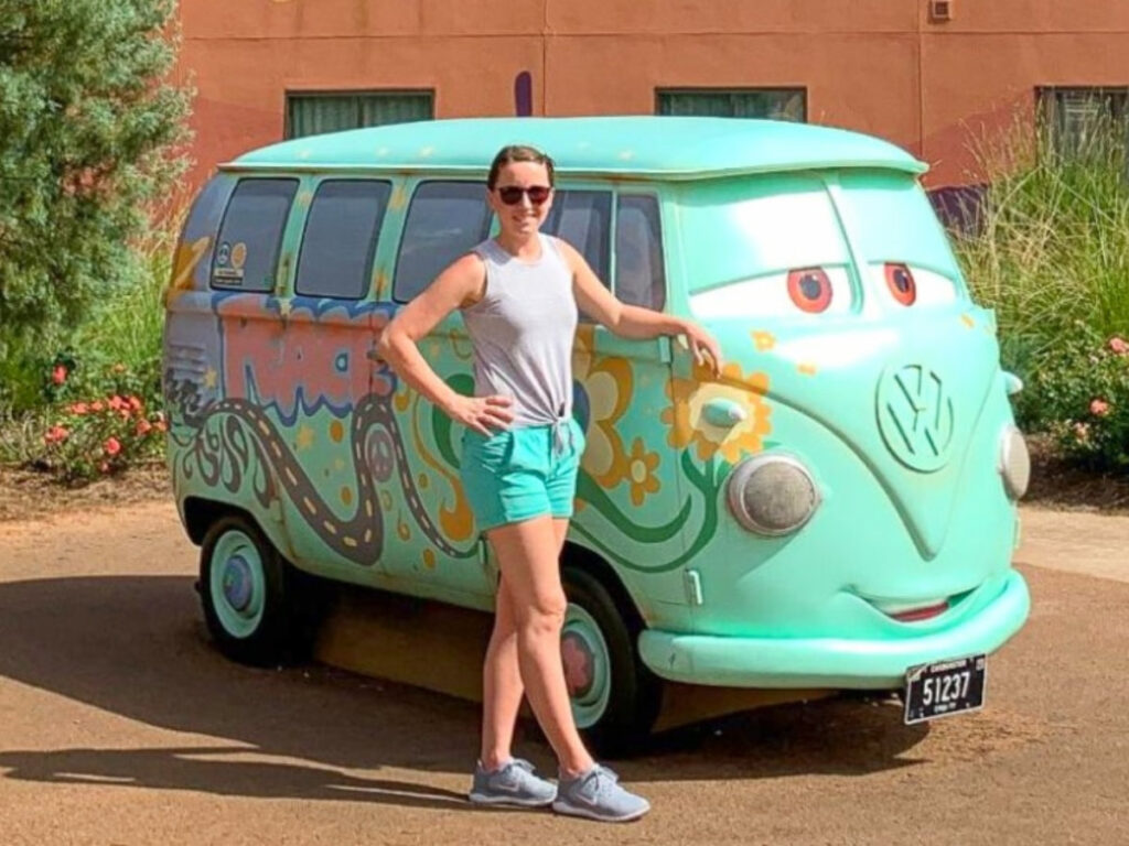 The author Katie, posing for a photo next to Fillmore, the Volkswagen bus
