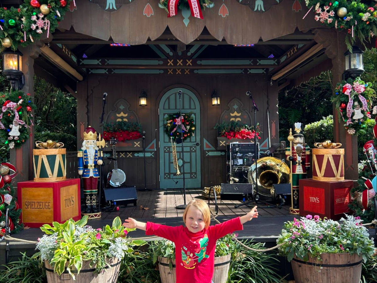 Katie's son posing for a photo at Epcot International Festival of the Holidays