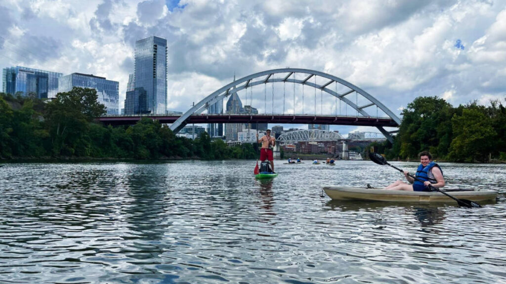 The author smiling for a photo while kayaking in Cumberland River