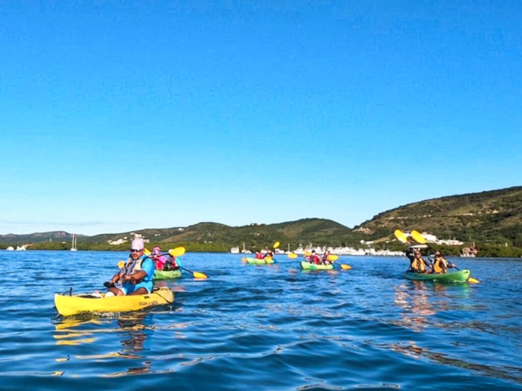 View of the tourists kayaking on La Parguera with mountain views in the background