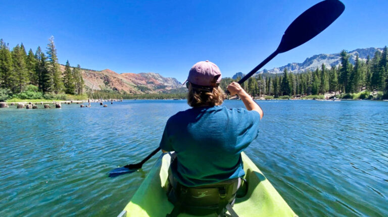 A woman kayaking on Lake Mary on a sunny day