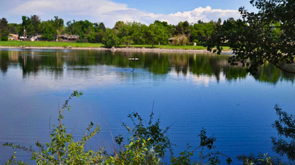 View of the lake surrounded by greenery at Ketring Park