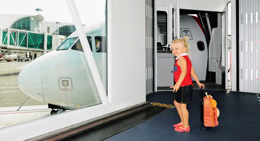 A little girl holding her bag waiting for boarding the flight