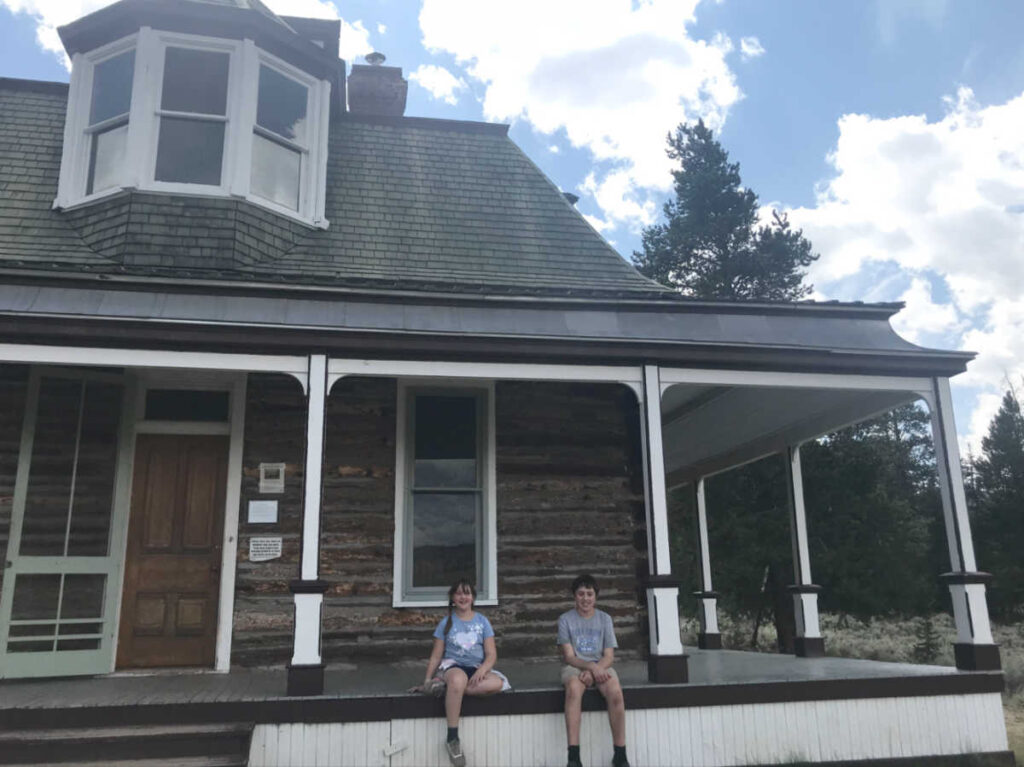 The kids sitting outside an abandoned building