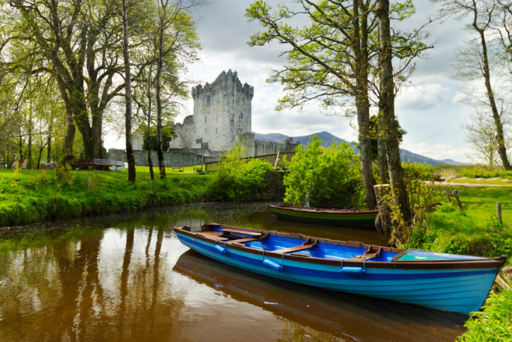A boat in front of Ross Castle in Killarney
