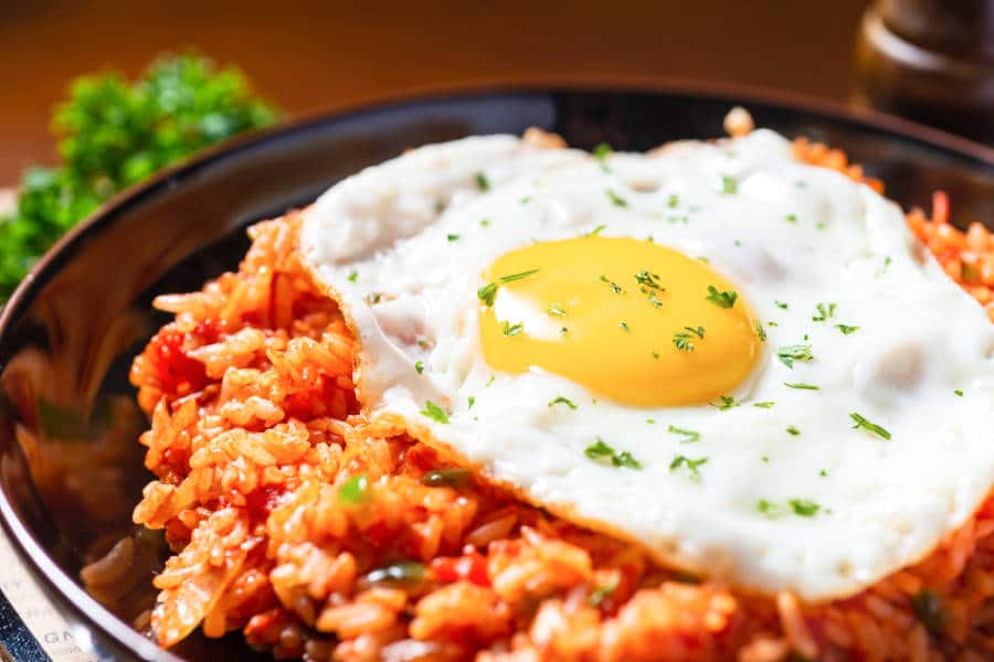 A bowl of kimchi fried rice topped with sunny side-up egg