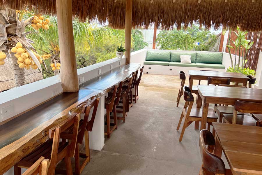 Chairs and tables at the rooftop of Kin Ha Tulum