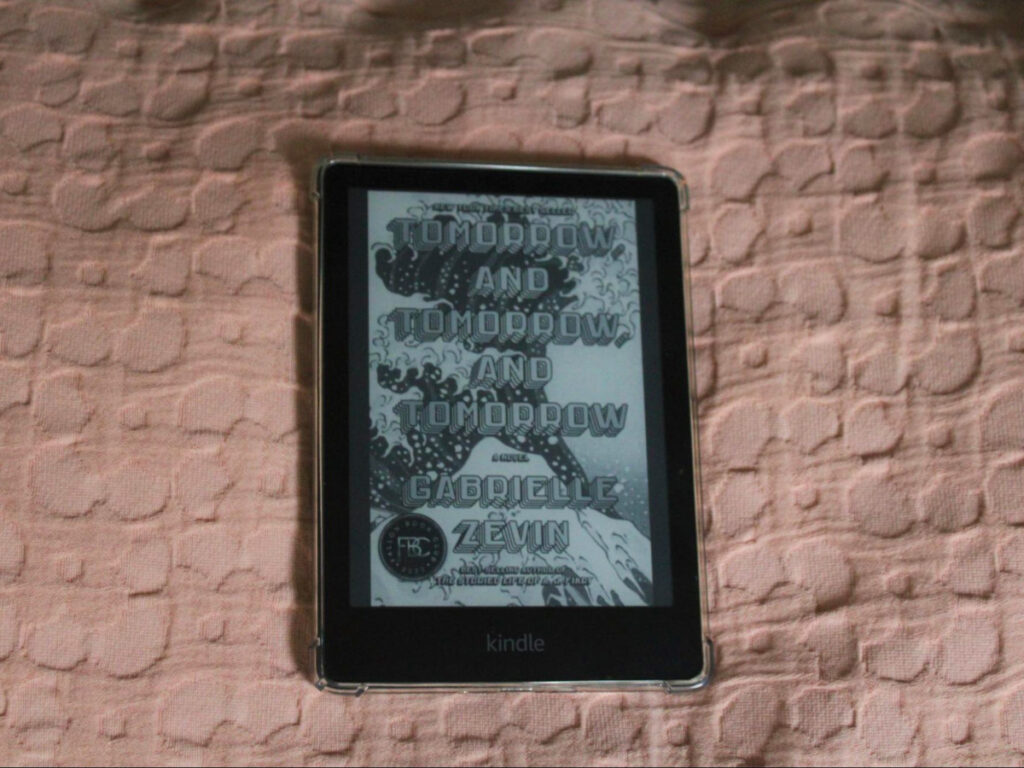 A Kindle E-Reader on a pink background