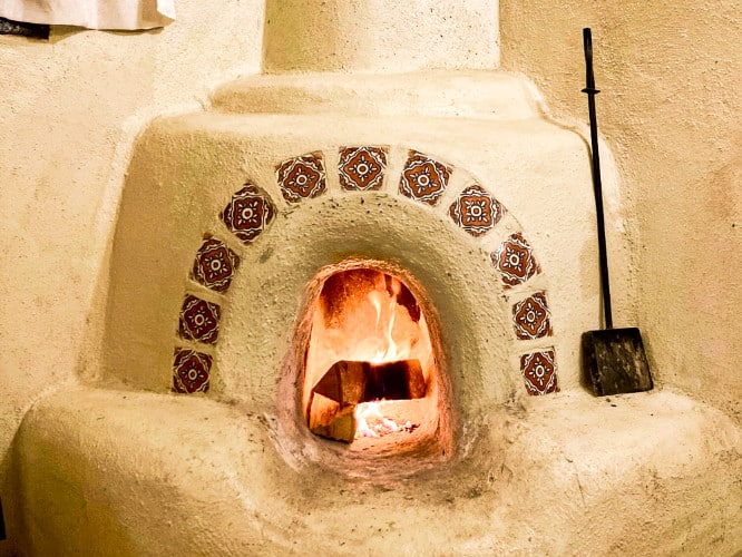 A closeup look at a classic kiva fireplace inside the room