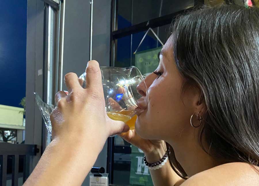 Close up view of the author drinking a beer from Knee Deep Brewing