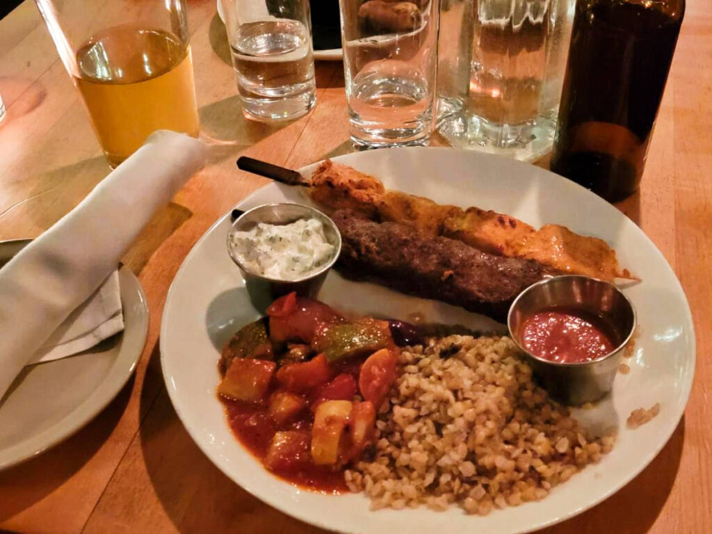 A huge plate of kofte (lamb) skewers with mushroom bulgur from Kashkaval Garden