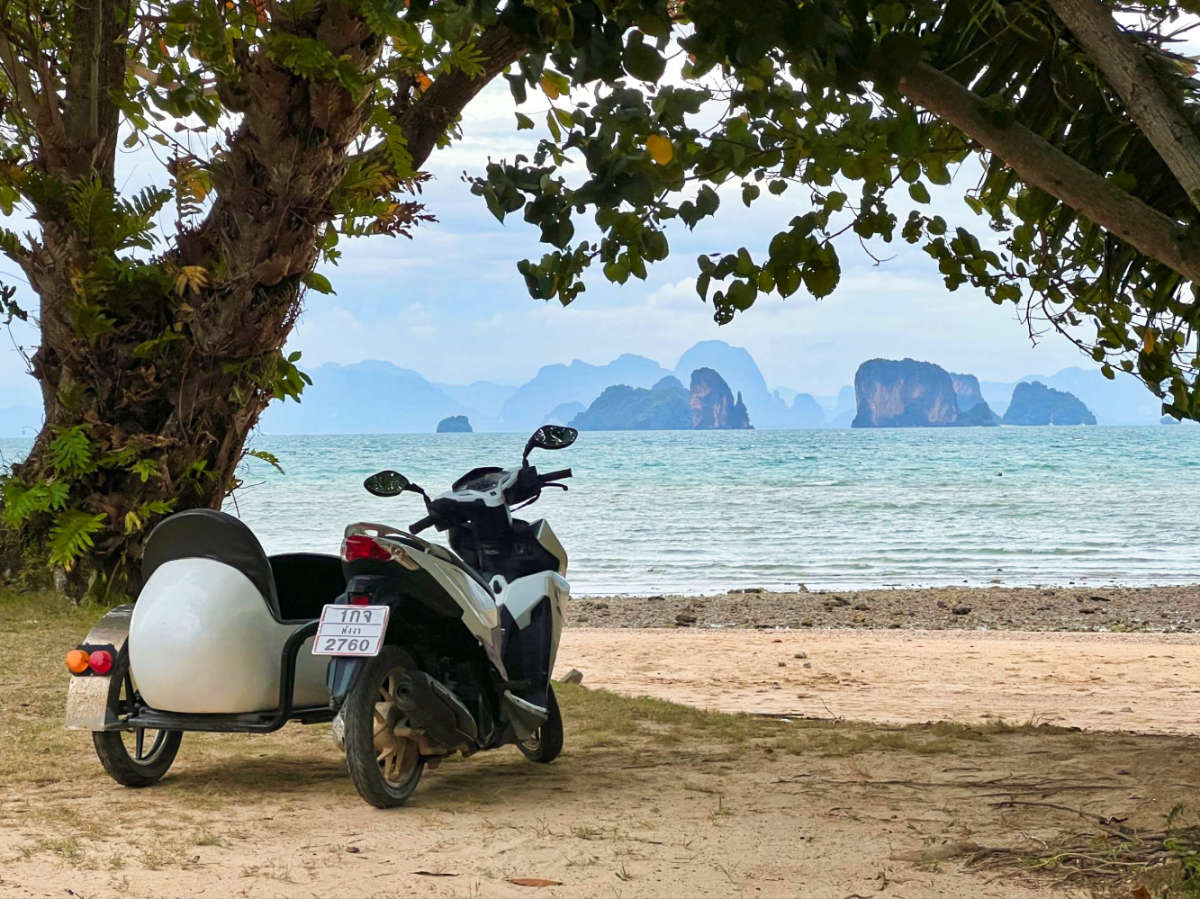 A motorcycle parked with scenic view of Koh Yaoi Noi