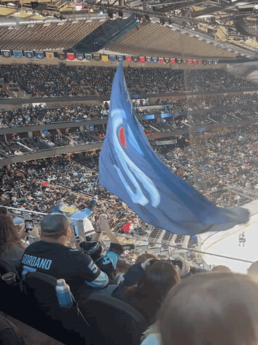 The Kraken mascot, Buoy, waving the rally flag during a game at Climate Pledge Arena