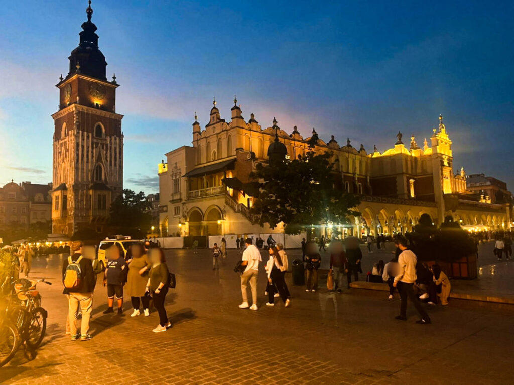 View of the crowd wandering around Stare Miasto at dusk