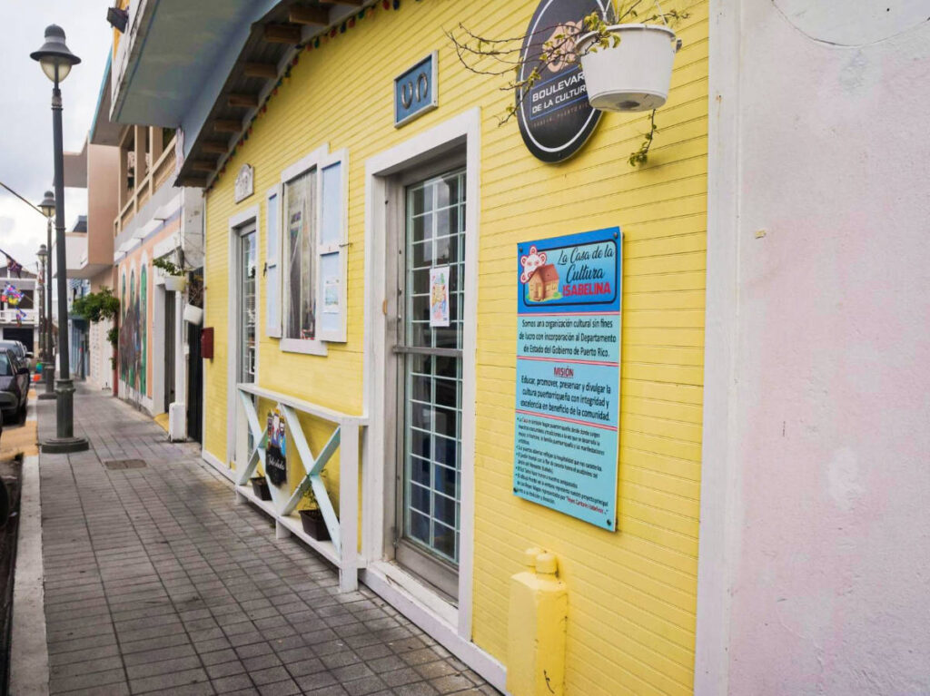 View of the vibrant yellow exterior of La Casa de La Cultura Isabelina