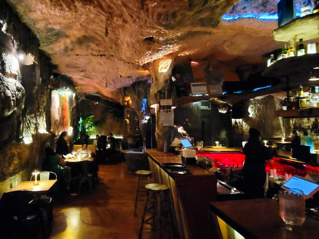 View of the people drinking inside the cave-like walls of underground bar