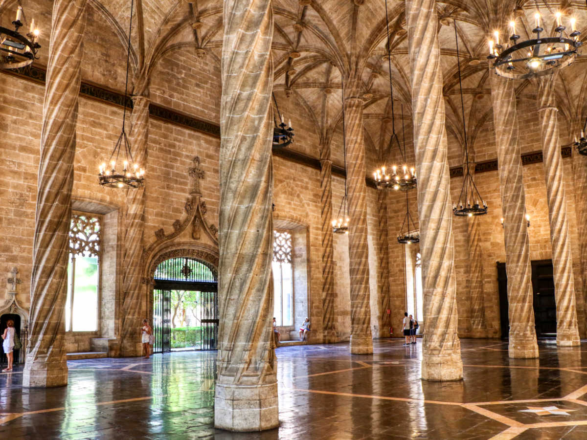 View of the intricate ceiling and column designs inside the La Lonja de la Seda