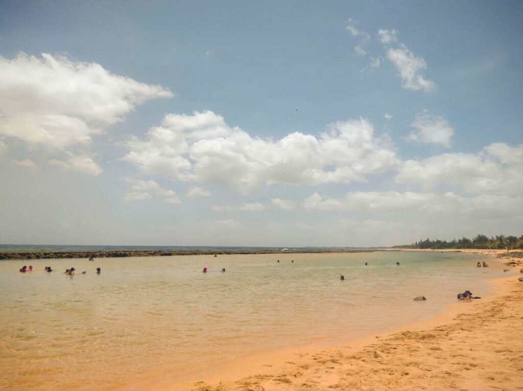 People swimming at La Posita de Piñones beach